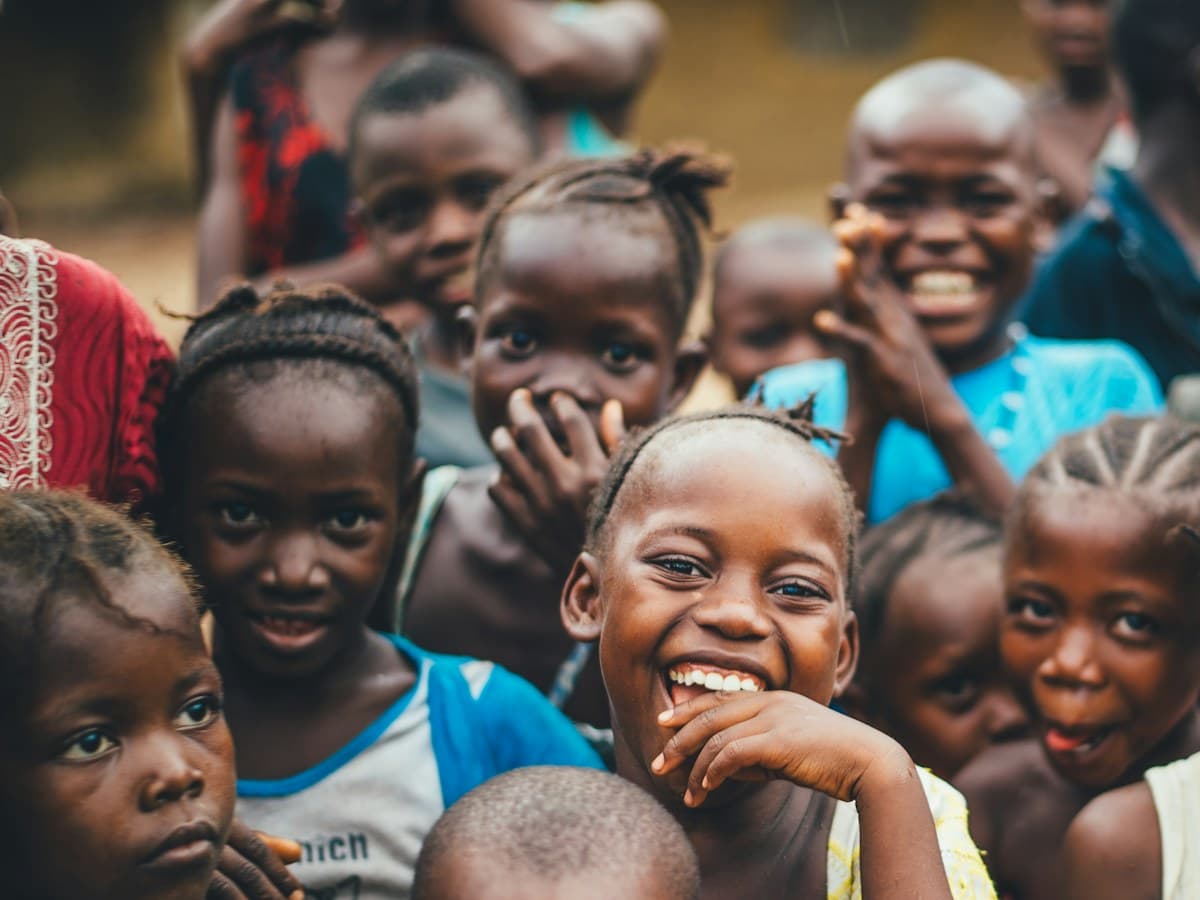 Children gathered and smiling together.